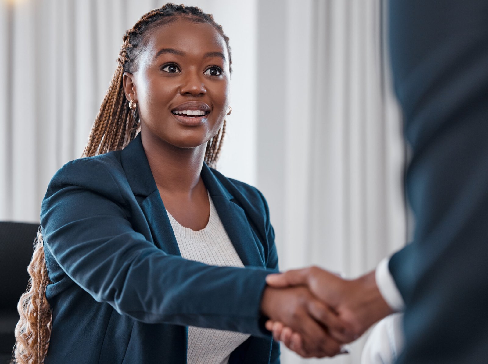 Business woman, handshake and agreement for partnership in office for collaboration, promotion or welcome. Black female entrepreneur and employee shaking hands for interview, greeting or b2b deal.